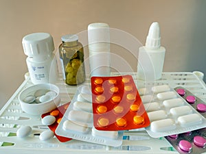 On the shelf are pills and drugs in packs, plastic and glass bottles with medical supplies. Background for drugstores, business, photo
