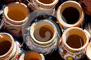 Shelf of small mexican ceramic pots in market at Old Town