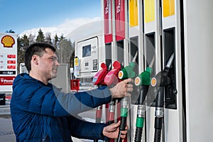 Shell gas station man fills car with gasoline