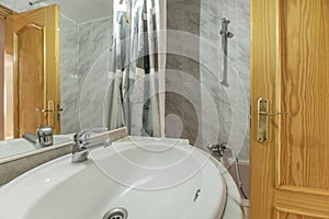 Shell-shaped white porcelain sink with chrome taps