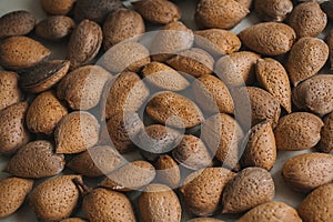 Shelled almonds as background. Close up view of shelled almonds texture and background for designers. Heap of almonds background.