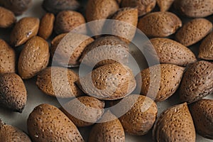 Shelled almonds as background. Close up view of shelled almonds texture and background for designers. Heap of almonds background.