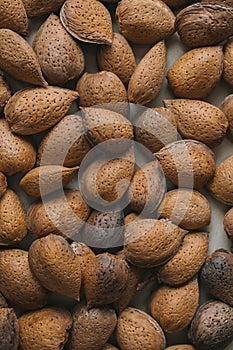 Shelled almonds as background. Close up view of shelled almonds texture and background for designers. Heap of almonds background.