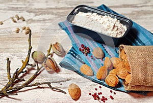 Almonds in a cloth bag and container with flour photo