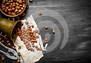 Shelled hazelnuts with Nutcracker and mortar of the old fabric.