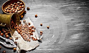 Shelled hazelnuts with Nutcracker and mortar of the old fabric.