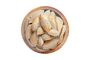 shelled paper almonds nuts in wooden bowl isolated on white background. Vegan food, top view