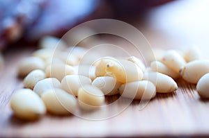 Shelled pine nuts on a wooden board