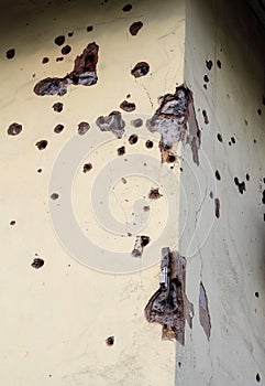 Shelled wall of a residential building. Consequences of the war in the Donbas. Housing stock of the DPR. Holes from fragments of a photo