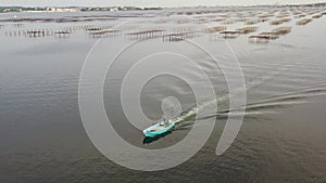 Shellfish boat returning to the port of Loupian, on the Thau lagoon in Occitanie, France