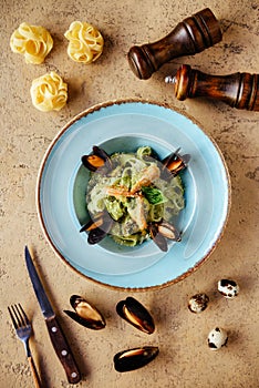 Shellfish Mussels in copper bowl with lemon and herbs. Shellfish seafood.