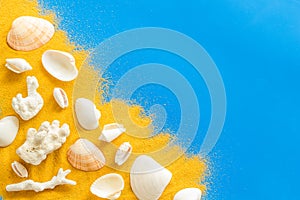 Shells on sand for seaside background for blog or desktop on blue table top view mock up