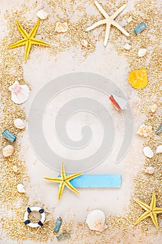 Shells and starfishes on sand background