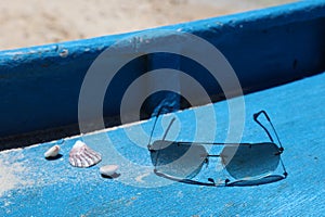 Shells and sun glasses on a boat deck, Boracay Island, Philippines