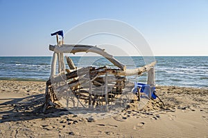 Shelter made of wood on a sandy beach near Salin de Giraud on a sunny day in springtime