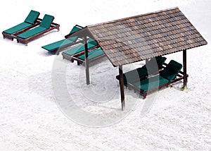 Shelter and relaxing beach chair on white sand