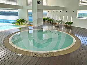 Sheltered round jacuzzi pool with sea view