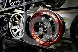 Shelves with alloy wheels and tires in modern car service centre