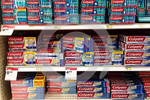 Shelves of Colgate brand toothpaste in a store