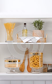 Shelves with raw foodstuff in kitchen