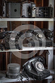 Shelves of Vintage Phones Cameras and Film Canisters