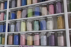 Shelving with glass jars of colorful pigments