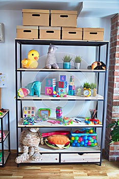 Shelving with lots of  colorful organized toys at kindergarten