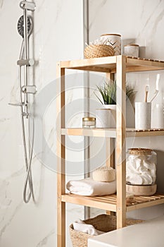 Shelving unit with toiletries in bathroom interior
