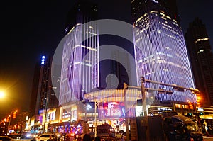 Shenzhen, China: night view of downtown bao `an, street and high-rise buildings and neon lights