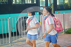 Shenzhen, China: after school in the afternoon, some students take their parents` electric bikes home, while others walk on their