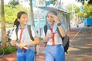 Shenzhen, China: after school in the afternoon, some students take their parents` electric bikes home, while others walk on their