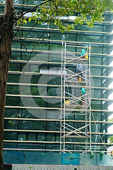 Shenzhen, China: workers clean glass curtain wall in high-rise building