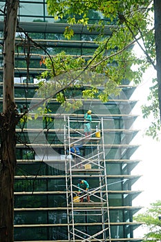 Shenzhen, China: workers clean glass curtain wall in high-rise building