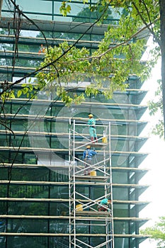 Shenzhen, China: workers clean glass curtain wall in high-rise building