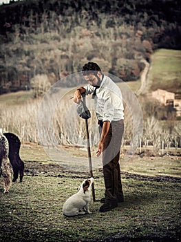 Shepherd plays with the dog at the end of a tiring day