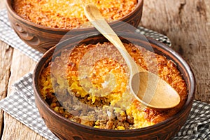 Shepherd`s Corn Pie Chilean Pastel De Choclo closeup in the pots. Horizontal photo