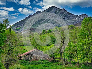 Shepherd\'s hut and PeÃÂ±a Manteca mountains in background, Belmonte de Miranda, Asturias, Spain photo