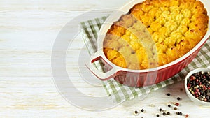 Shepherd's Pie or Cottage Pie, traditional British dish on white wooden background