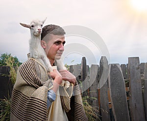 Shepherd with a sheep in his arms