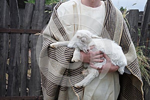 Shepherd with a sheep in his arms