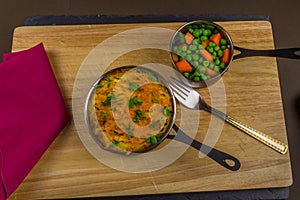 Shepherds or cottage pie in serving dish with parsley