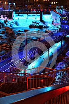 Sherbrooke Magog River downtown at night. Blue illuminated power dam river with penstock and steel catwalk.