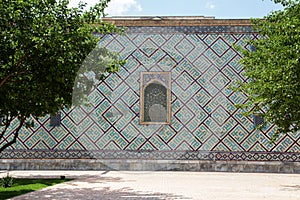 Sherdor Madrasah on Registan Square in Samarkand in Uzbekistan. Side mosaic wall. 29.04.2019