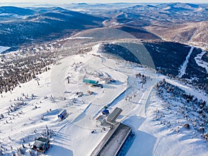 Sheregesh Kemerovo region ski resort in winter, landscape on mountain and hotels, aerial top view