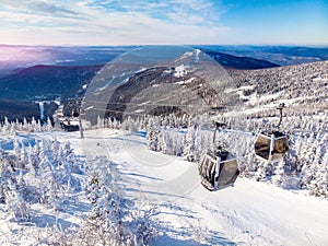 Sheregesh ski lift resort in winter, landscape on mountain and hotels, aerial top view Kemerovo region Russia