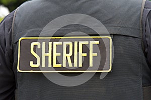 Sheriff letters on back of a flack jacket, close up