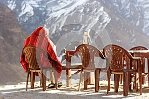 Sherpa warming up in the sunrise at the Annapurna Base Camp, Nepal