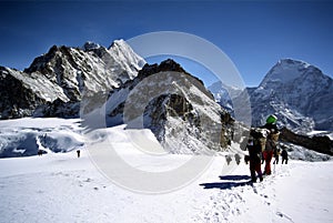 Sherpas and climbers crossing an Himalayam glacier