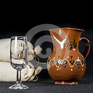 Sherry glass beside a pottery jug to serve wine