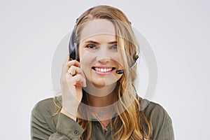 Shes always available to take your call. Studio portrait of an attractive young female customer service representative